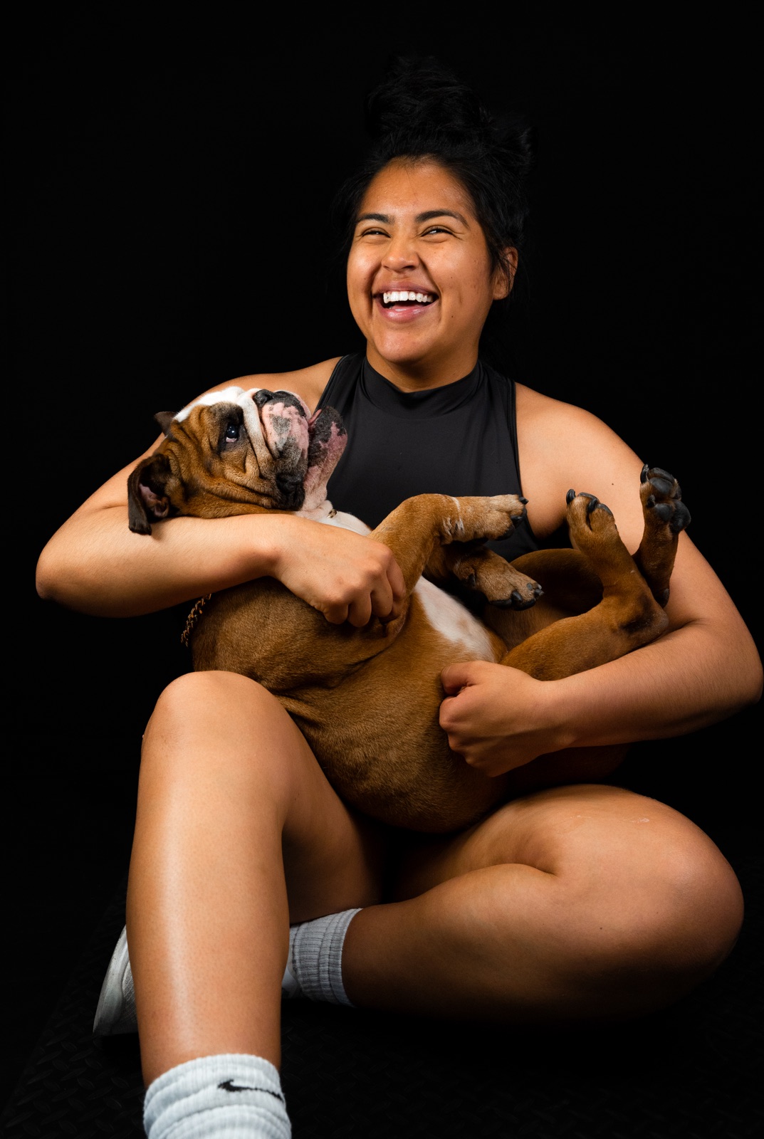 Brassy, founder of the Paw Army, holding Lebron her rescue English Bulldog